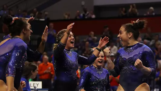 Amelia Hundley (right) celebrates her floor routine with the Gators 200124