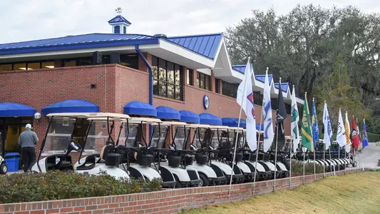 Mark Bostick Golf Course Clubhouse with golf carts and team flags