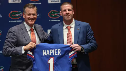Scott Stricklin presents Billy Napier with a Gators jersey