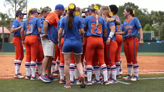 Softball team huddles during Super Regional against Georgia