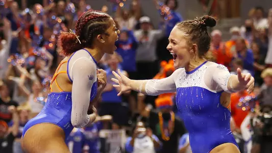 Nya Reed celebrates her 10.0 floor routine with Savannah Schoenherr (right) 220211