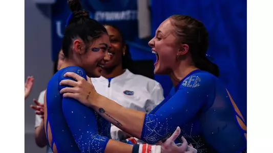 Savannah Schoenherr celebrates Kayla DiCello's uneven bars 10.0 230331