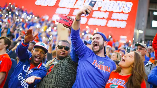 Fans with phones held high sing Won't Back Down in The Swamp