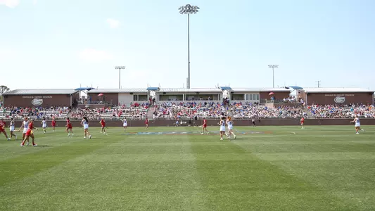 Lacrosse players run up field at Dizney Stadium