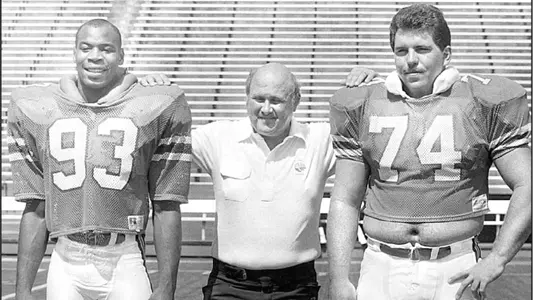 Johnson, Alonzo (pictured on left, with Coach Galen Hall and OL Jeff Zimmerman, via Orlando Sentinel files)