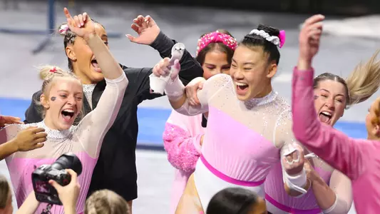Leanne Wong celebrates her 10.0 uneven bars routine with the Gators 240209