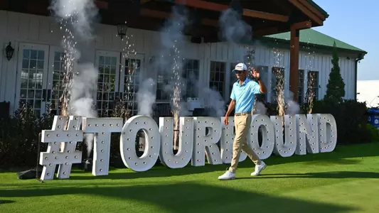 FRENCH LICK, INDIANA - OCTOBER 06: Ricky Castillo walks past the #TOURBOUND sing during the card ceremony after the final round of the Korn Ferry Tour Championship presented by United Leasing and Finance at French Lick Golf Resort - Pete Dye Course on October 6, 2024 in French Lick, Indiana, United States. (Photo by Tracy Wilcox/PGA TOUR via Getty Images)