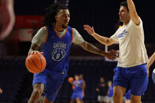 Boogie Fland dribbles past assistant coach Dave Klatsky during practice.