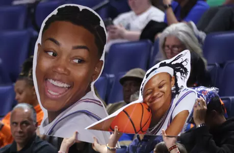 Fans hold up Big Heads of Liv McGill and Me'Arah O'Neal at the Gators' win over West Georgia