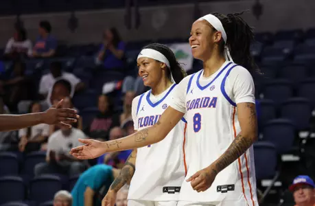 Me'Arah O'Neal and Jade Weatherspoon smiling after a made basket and a foul vs. Furman