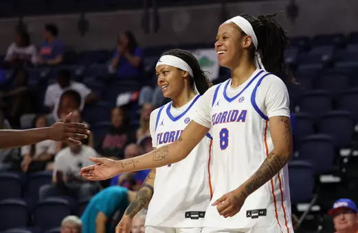Me'Arah O'Neal and Jade Weatherspoon smiling after a made basket and a foul vs. Furman