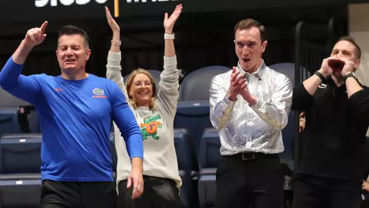 Adrian Burde, Jenny Rowland, Jeremy Miranda and Owen Field cheer a Gator routine at WVU triangular - 250202