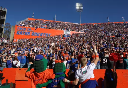 Albert, Alberta and three cheerleaders sing We Are The Boys with the fans in The Swamp
