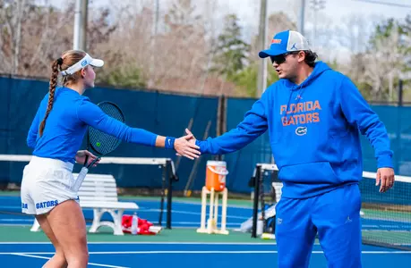 Nikola Daubernova and assistant coach Axel Damiens share a congratulatory handshake at Charleston Southern