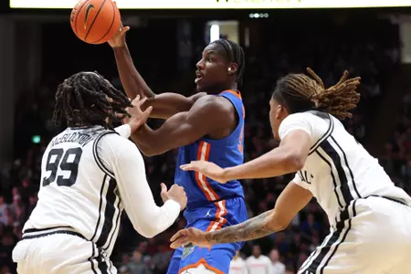 Rueben Chinyelu handles the ball between two defenders at Vanderbilt