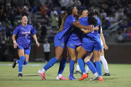 Freshman Courtney Hogan is sandwiched by Lena Bailey (left) and Kyra Taylor (#3) after her tying goal versus Auburn. 261022