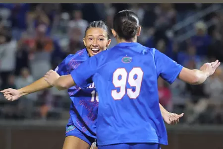 Courtney Hogan (facing camera) rushes to celebrate with Katie Johnston vs Auburn 261022.