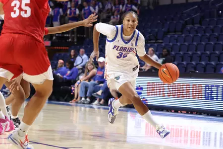 Kiyomi McMiller drives into the lane against Flagler