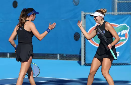 India Houghton and Lucie Lawlak excahnge a high five following a win vs. Troy