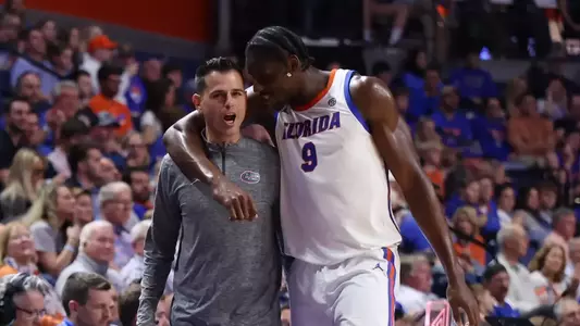 Head coach Todd Golden and Rueben Chinyelu talking on the sideline