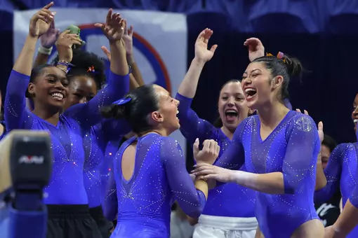 Alyssa Arana (center) celebrates her balance beam routine with Kayla DiCello