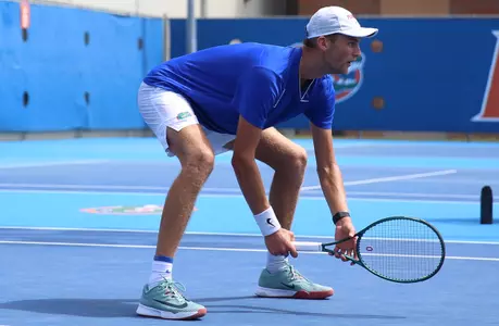 Henry Jefferson crouching near the net, waiting for teammate Jeremy Jin to serve in doubles match.