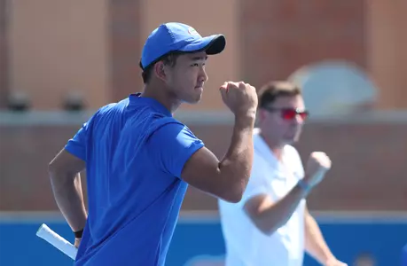 Jeremy Jin celebrating a point with Coach Anthony Rossi in the background.