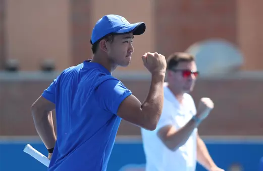 Jeremy Jin celebrating a point with Coach Anthony Rossi in the background.