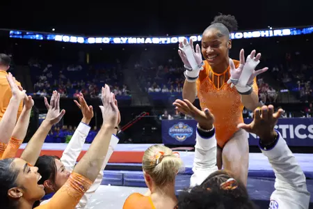 Skye Blakely high fives after her 9.975 uneven bars routine at the SEC Championship meet 260321