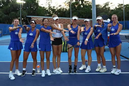 The Florida Women's Tennis Team (2025-26) celebrates its 4-0 win over Alabama with a group Gator Chomp!
