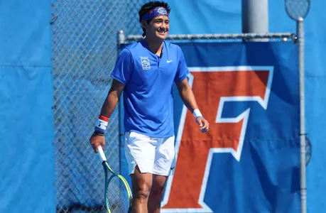 Tanapatt Nirundorn smiling on court post point in doubles.