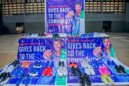 Shoes sent back to Nigeria by Rueben Chinyelu are displayed with signs that say "Rueben Chinyelu gives back to the Community."