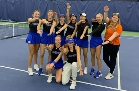 The Women's Tennis Team celebrates its win over Ole Miss with a group Gators Chomp