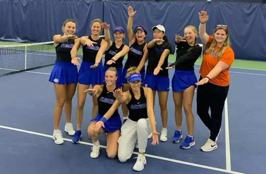The Women's Tennis Team celebrates its win over Ole Miss with a group Gators Chomp