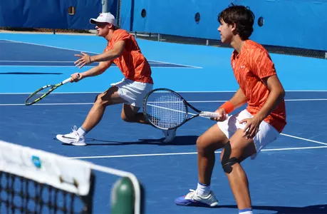 Kevin Edengren and Andreas Timini playing the net during doubles against FGCU.
