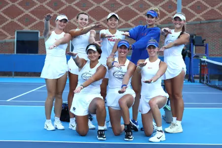 The Women's Tennis celebrates its win over No. 13 Vanderbilt with a Gator Chomp