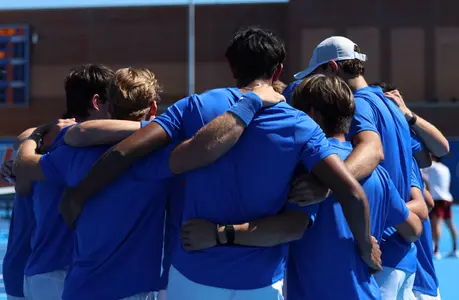 Florida men's tennis team in a huddle following the loss of a doubles point to South Carolina.