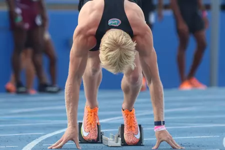 Garrett Fox lines up on the blocks at the start line for the Gators