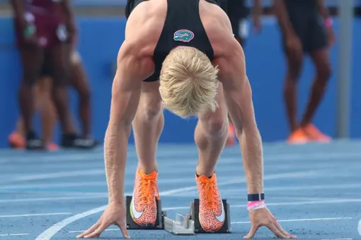 Garrett Fox lines up on the blocks at the start line for the Gators