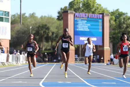 Gabrielle Matthews crosses the finish line first at the track and field Tom Jones Memorial