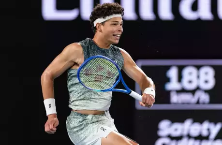 Ben Shelton at the 2026 Australian Open smiling following a point on court.