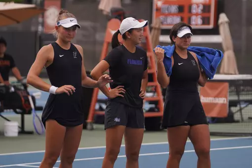 Nikola Daubnerova, Xinyi Nong and Valery Gynina look on during the Gators' match at Texas
