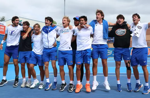 Florida men's tennis team (left to right: Lorenzo Claverie, Andreas Timini, Jeremy Jin, Roman Sancilio, Kevin Edengren, Adhithya Ganesan, Tanapatt Nirundorn, Pablo Perez Ramos, Francesco Cordova, and Christo Timini) cheering during doubles.