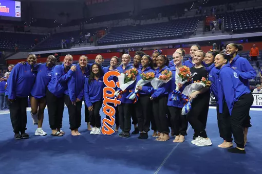 Florida seniors Lori Brubach, Selena Harris-Miranda, eMjae Frazier, Riley McCusker and manager Peyton Harbert are surrounded by the 2026 Gators team at Senior Night. 260308 vs LSU