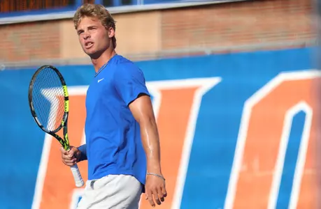 Junior Kevin Edengren holding his racquet on court six after playing a point in singles at home against Vanderbilt.