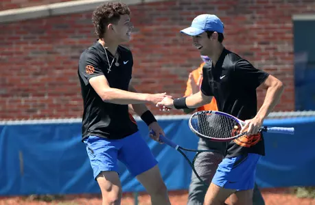 Ben Shelton and Andy Andrade celebrating a point in doubles for the Gators in 2021.