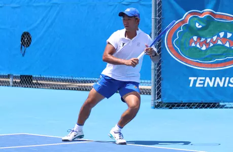 Jeremy Jin in motion to hit a ball on the baseline of the tennis court in singles against LSU.