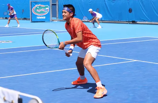 Tanapatt Nirundorn ready to volley at the net in doubles against the LSU Tigers on senior day.