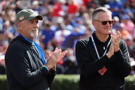 Phil Pharr and Scott Stricklin on the field during the Gators' game against the Arkansas Razorbacks on Saturday, November 4, 2023 at Ben Hill Griffin Stadium in Gainesville, Fla. / UAA Communications photo by Maddie Washburn