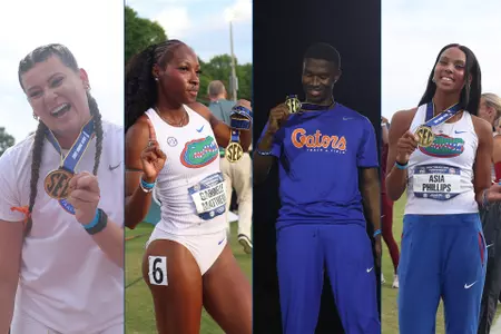 Four athletes for the Florida Gators show off their gold medals at Auburn's track.